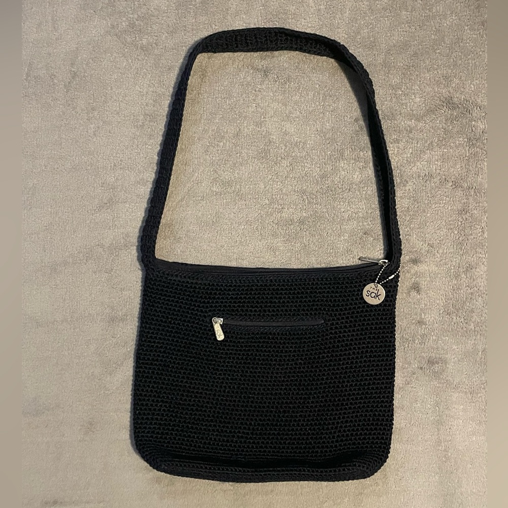 The Sak crocheted navy shoulder bag with two zippered pockets